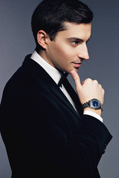 istock Handsome man in suit with watch on white background. 465096322