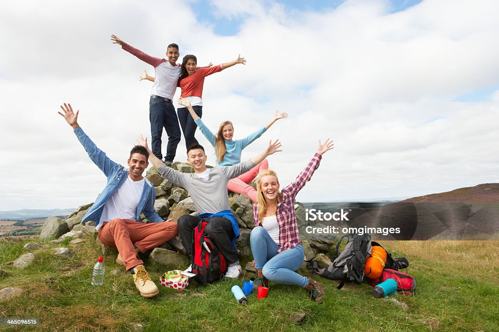 Group of young people hiking in the country Group Of Young People Hiking In Countryside Smiling At Camera Teenager Stock Photo