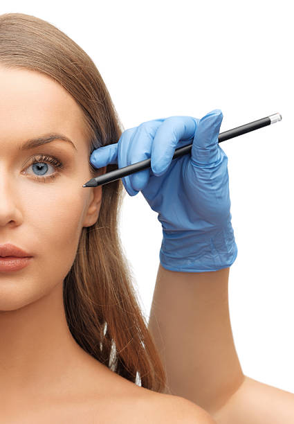 istock woman face and beautician hands 465096569