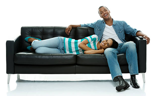 istock Cheerful couple on sofa and laughing 465098456