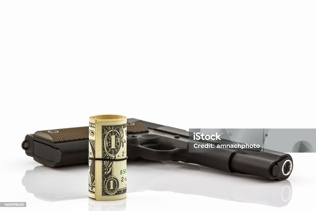 Close up money with Gun. Close up money with Gun on white background. 2015 Stock Photo