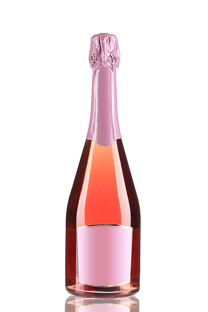 botlle розового фрукты и шампанское. - champagne pink bottle isolated стоковые фото и изображения