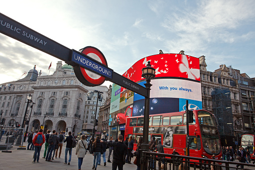 London, UK - April 28, 2014: People just step out of the subway (Underground) on the famous Piccadilly circus square in London.