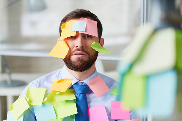 Bearded office worker covered with post-it notes