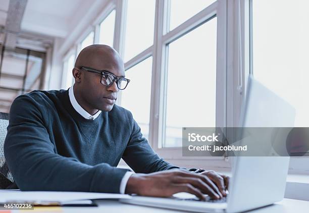 African American Businessman Working On His Laptop Stock Photo - Download Image Now - People, Research, Computer