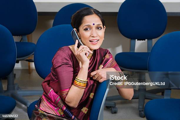 Businesswoman Communicating On Cell Phone Stock Photo - Download Image Now - 2015, Adult, Adults Only