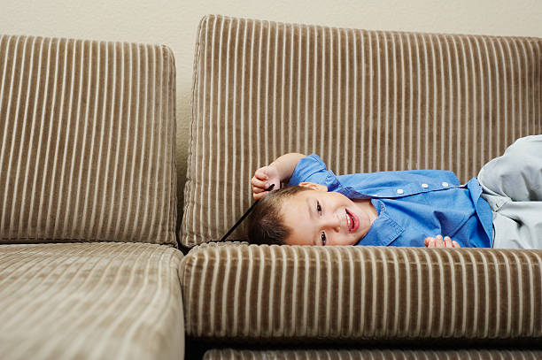 istock Boy relaxing on sofa in living room 465104198