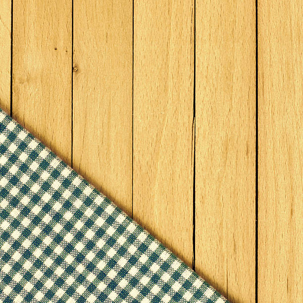 istock Checkered tablecloth laying on wooden table 465105494