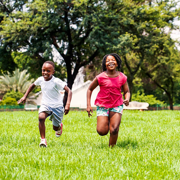 istock African kids running together in park. 465107184