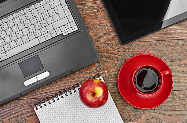 istock Laptop and office supplies on wooden table 465107719