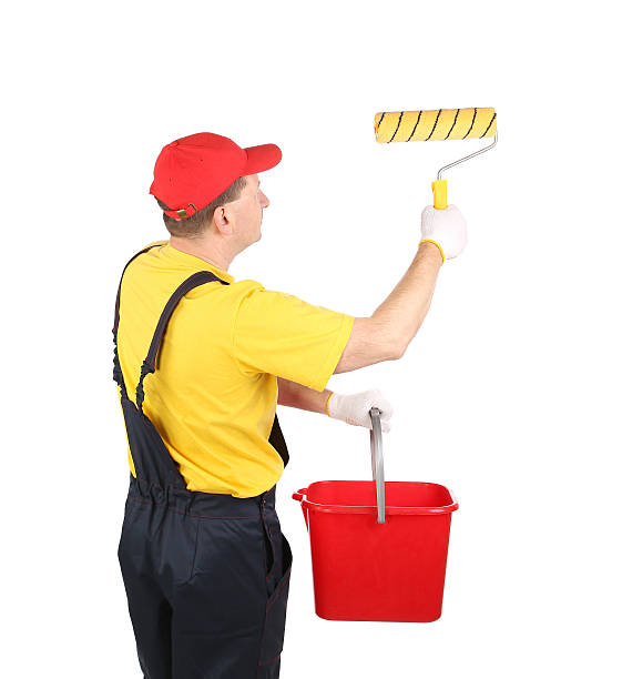 istock Worker in hardhat paints with bucket. 465110047