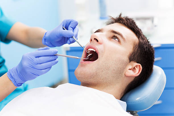 Man having teeth examined at dentists Man having teeth examined at dentists dental drill stock pictures, royalty-free photos & images