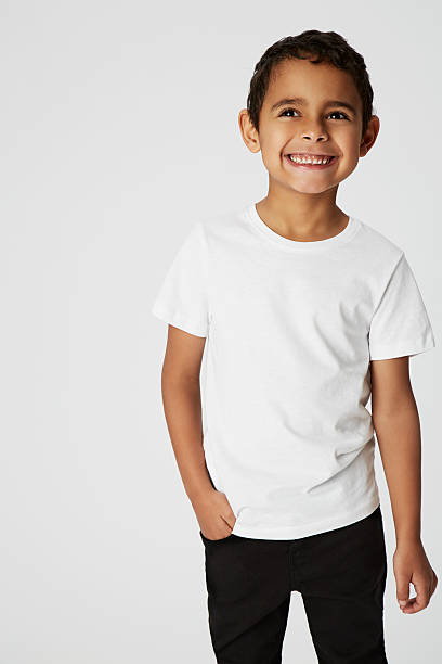 Cheeky boy, smiling Boy with cheeky smile in studio three quarter length photos stock pictures, royalty-free photos & images