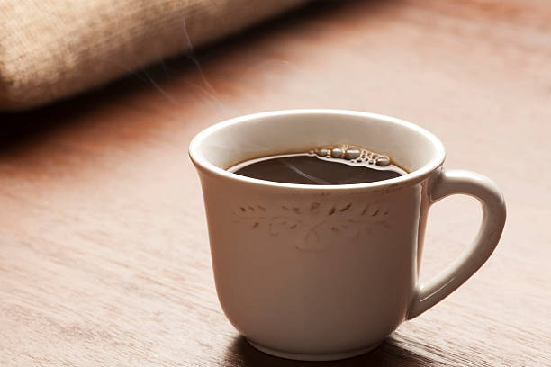 istock Coffee cup with smoke on wooden table 465114998