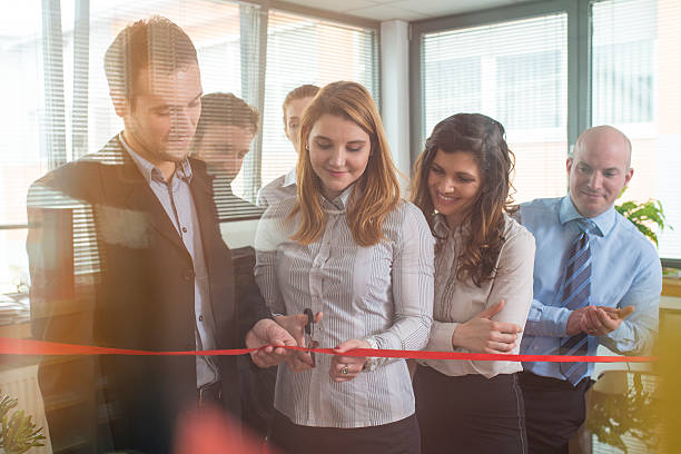 istock Teammates at an office cutting a ribbon for a new beginning 465115614