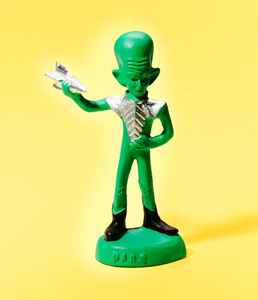 Green Alien Holding Small Spaceship