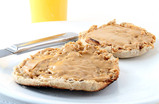 English muffin breakfast Whole wheat english muffin with peanut butter and orange juice. english muffin stock pictures, royalty-free photos & images