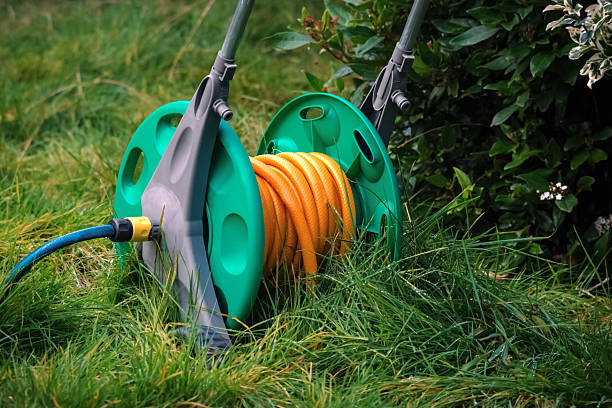 istock Watering hose on grass in the garden 465118090