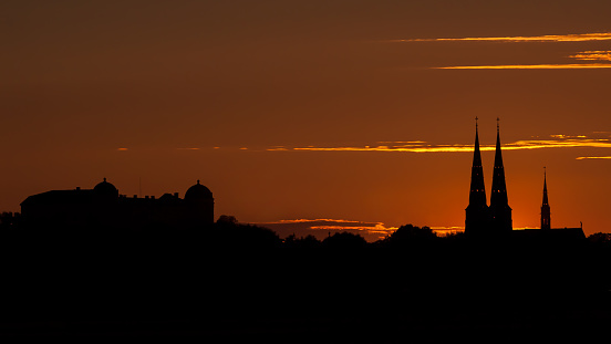 Uppsala Skyline in the sunset with the silhouettes of Uppsala Castle and Uppsala Cathedral, Sweden