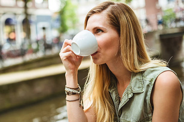 istock Smiling woman holding a coffee cup 465119374