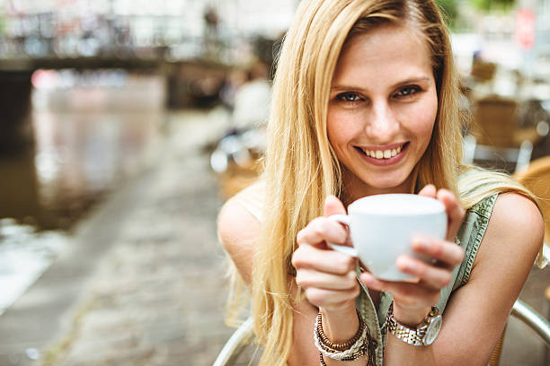 istock Smiling woman holding a coffee cup 465119378
