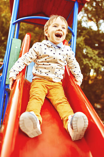 istock A smiling little boy on a slide 465119922