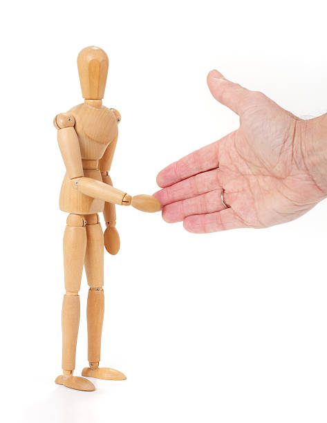 istock Wooden man figure shaking hands, isolated on white background 465121118