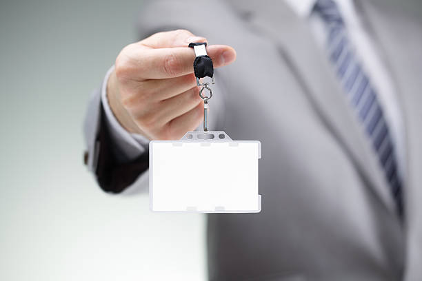 Businessman holding blank ID badge
