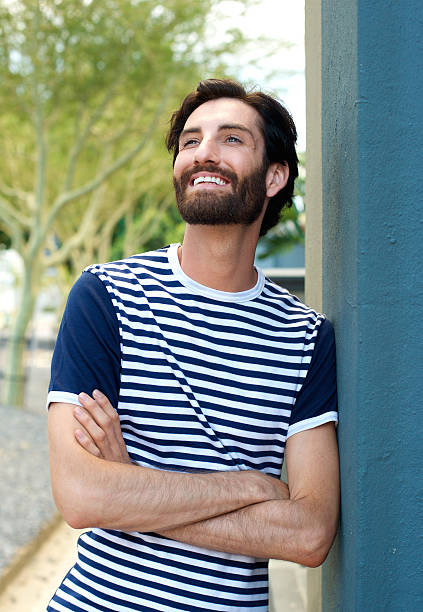 istock Charming young man smiling with arms crossed 465123648