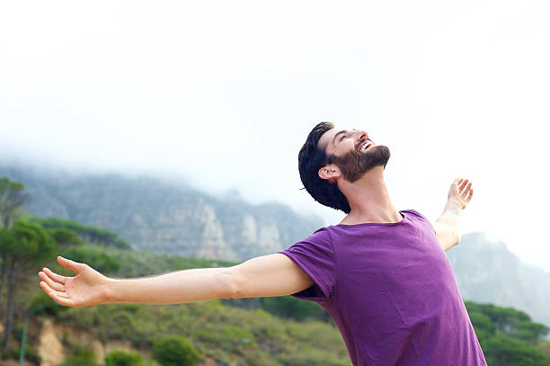 istock Carefree man smiling with arms open 465123838