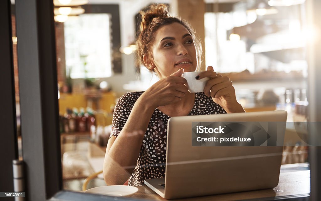 Great coffee for inspired people Shot of a beautiful woman enjoying a cup of coffee with her laptop open in front of herhttp://195.154.178.81/DATA/istock_collage/a5/shoots/785124.jpg 20-29 Years Stock Photo