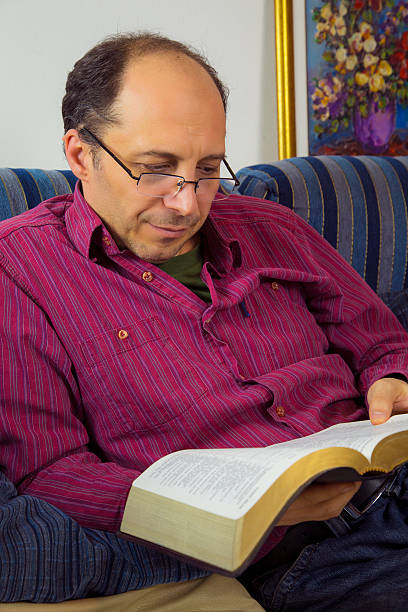 istock Adult man reading a bible 465124454