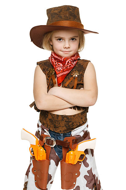 Little girl wearing cowboy costume standing with folded hands, over white background