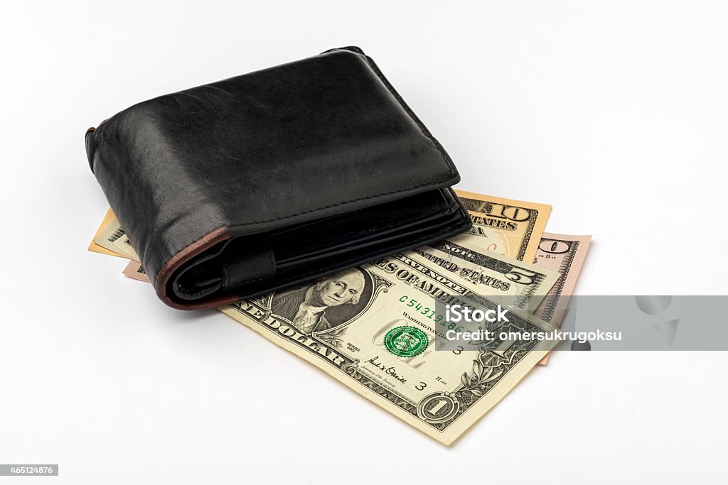 Closeup of US Dollars in a Man's Leather Wallet US Dollars in a man's leather wallet on a white background. 2015 Stock Photo