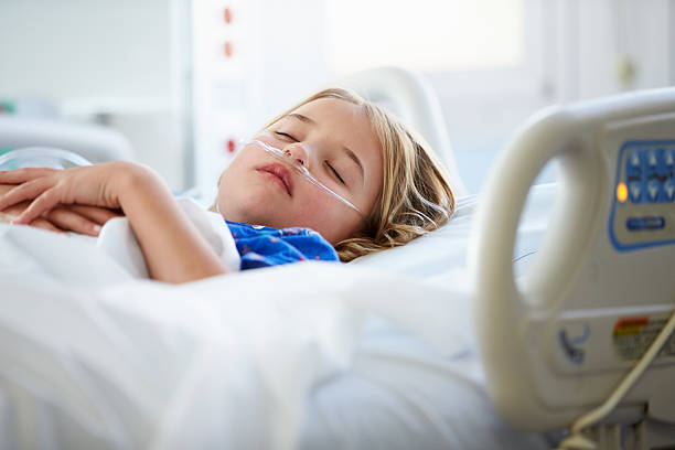 Young Girl Sleeping In Intensive Care Unit Peaceful And Relaxed Young Girl Sleeping In Intensive Care Unit intensive care unit stock pictures, royalty-free photos & images