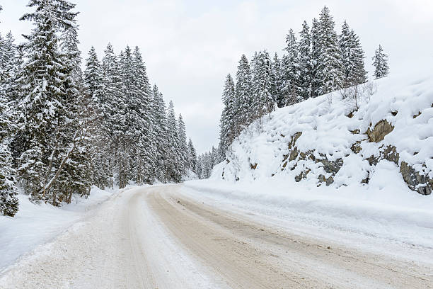 istock Slippery and icy road in a winter landscape 465125702