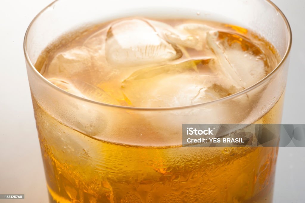 Whisky And Ice Cubes Close-Up Medium Glass With Whisky And Ice Cubes Inside Of It, Seen From Top. Photo Produced In A Studio, On White Background. 2015 Stock Photo
