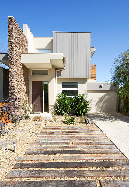Contemporary double storey townhouse home Front of a two storey contemporary architect designed townhouse home vertical format pebble driveway stock pictures, royalty-free photos & images