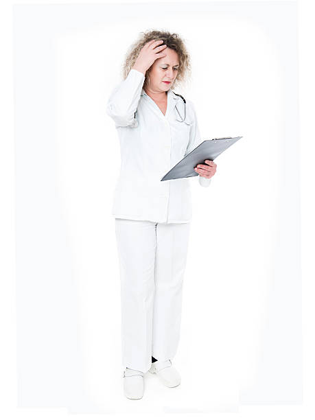 istock Mature Female Doctor Banging her Head Realizing a Mistake 465126584