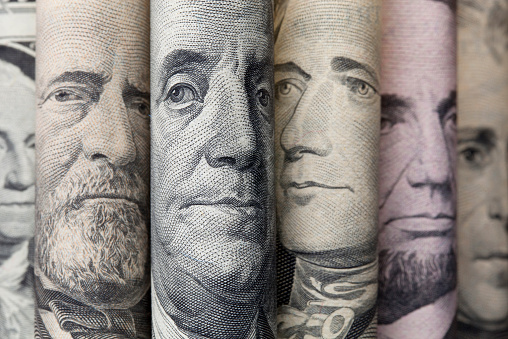 Portraits of U.S. presidents on dollar bills.