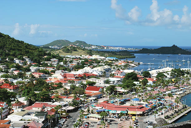 Panoramic View of Marigot Town in St Martin Island. Nice promenade walk in the harbor of Marigot city has newly constructed rows of upscale shops, hotels and restaurants.