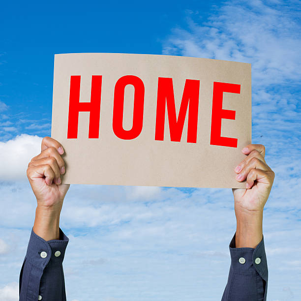 istock Man hand holding paper with home word 465128877