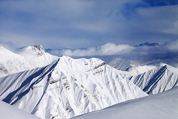 istock Off-piste slope and cloudy mountains at nice evening 465129227