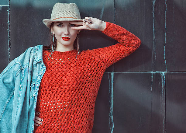 istock Young beautiful girl in red jersey with hat 465130110