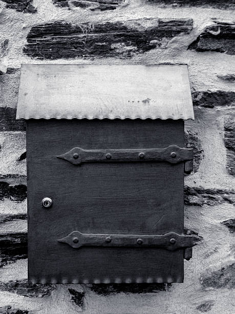 istock postbox on a wall in black and white 465130204