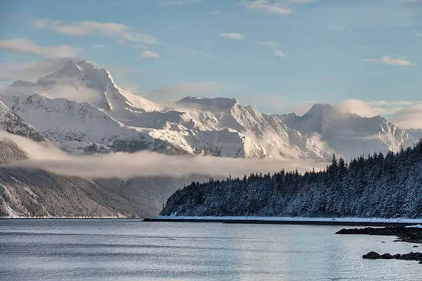 View of tall mountains from Viking Cove in southeast Alaska in winter.