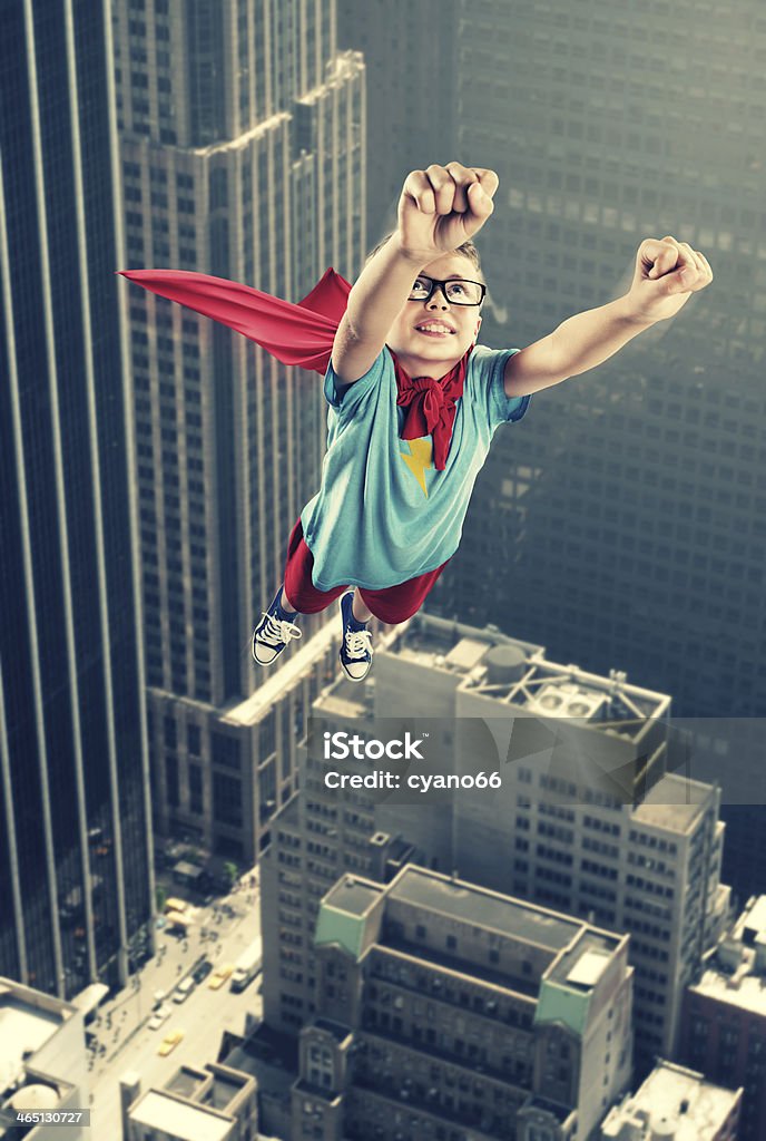 A little boy dressed as a superhero flying like Superman A little superhero ready to save the world Adolescence Stock Photo