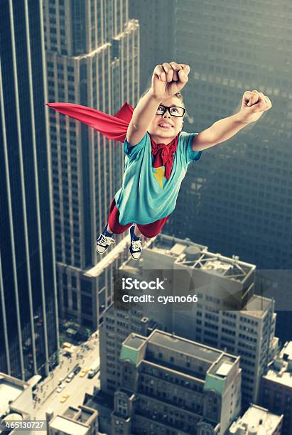 A Little Boy Dressed As A Superhero Flying Like Superman Stock Photo - Download Image Now