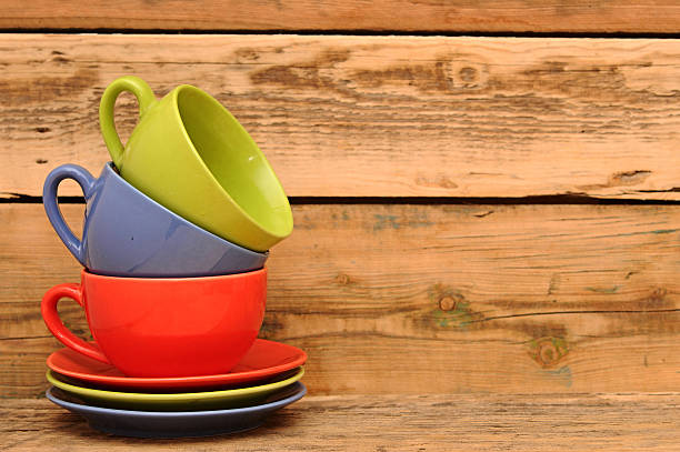 istock Colorful cups on the wooden background 465130977