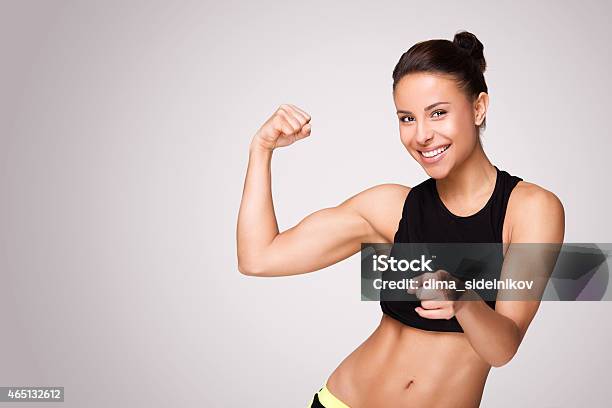 Mixed Race Woman Demonstrating Biceps Stock Photo - Download Image Now - 20-29 Years, 2015, Activity